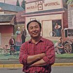 Arthur Cheng with Star Works Novelty Works mural in the background